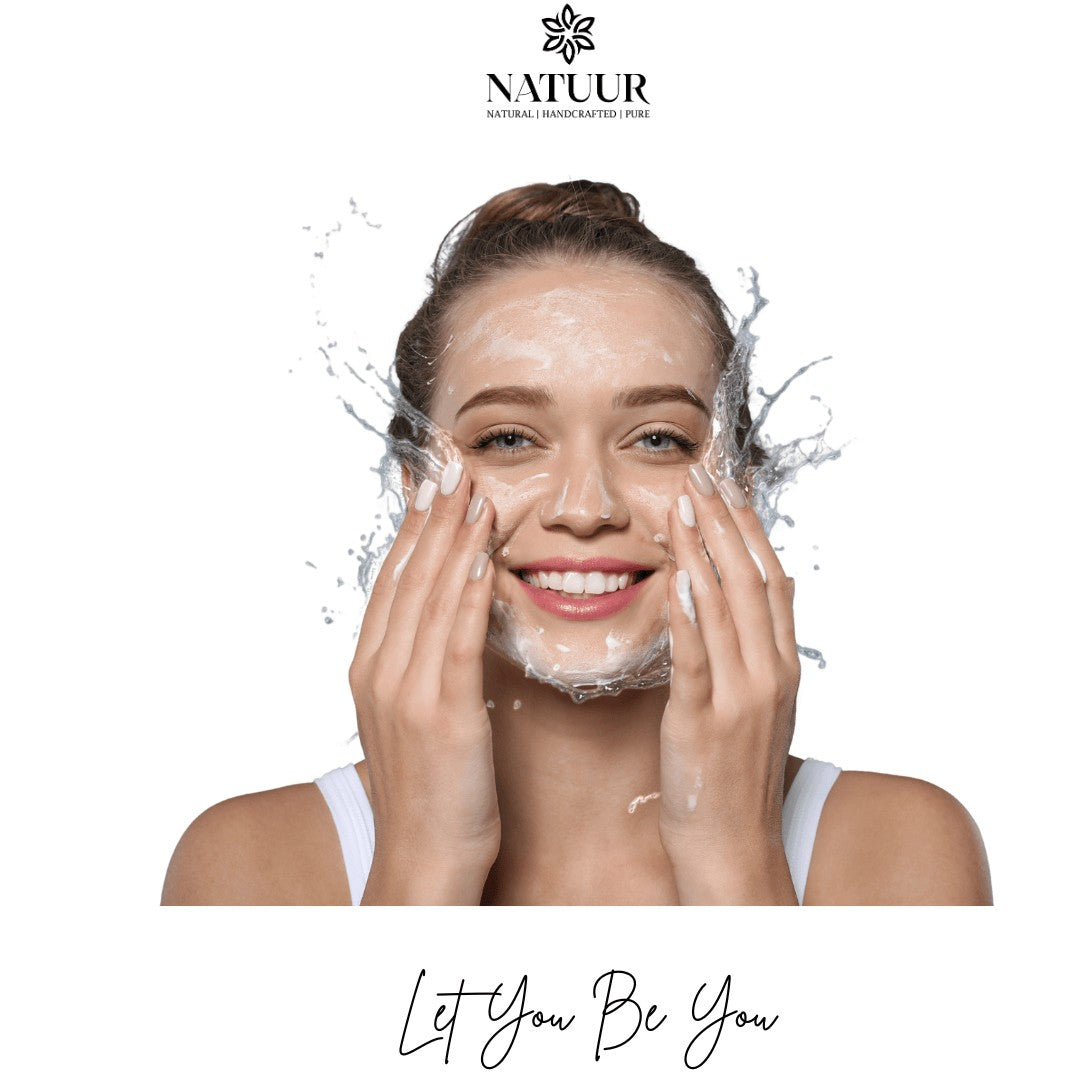 Natuur.in clarifying cleanser with salicylic and glycolic acid being applied by a smiling woman with water splashes