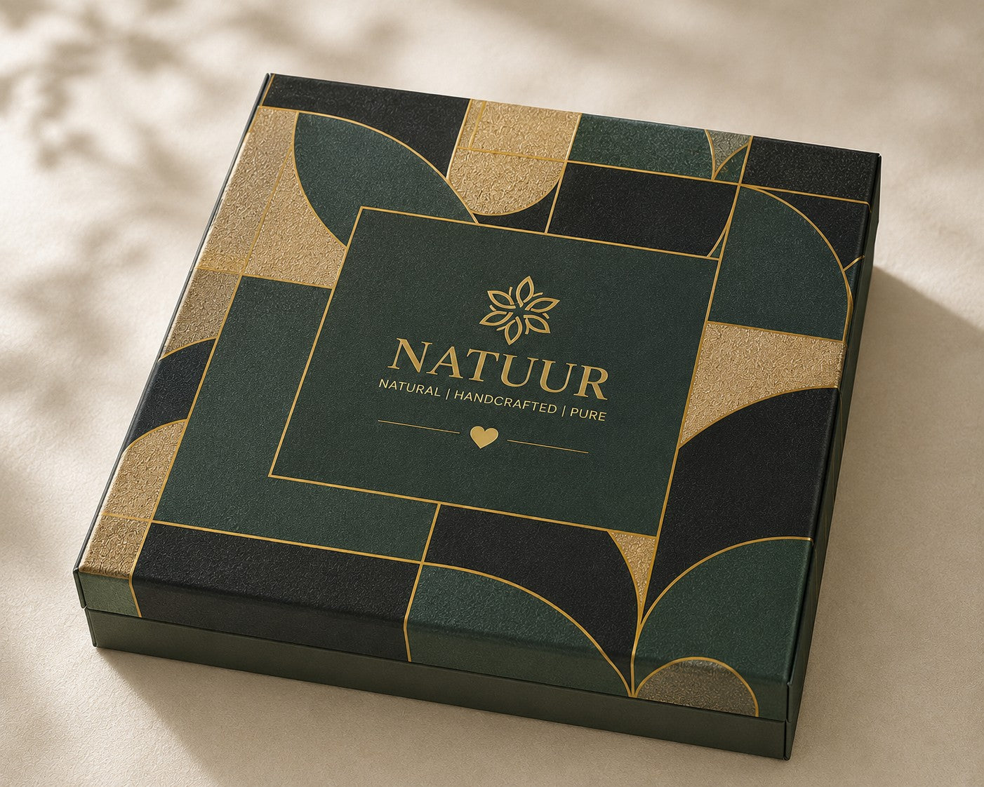Natuur.in luxury wellness gift box in forest green with gold geometric accents and elegant branding on the lid.